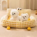 A cozy FluffyEye Haven Plaid Pet Sofa from bichonshop.com, the ultimate comfort spot for Bichons and Malteses, available at Bichon Shop